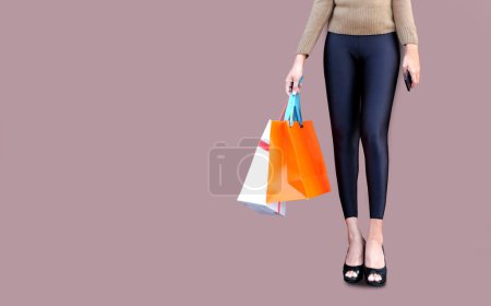 Photo for Women use smartphone shopping online , Fashion outfit stylish clothes. Carry a colorful shopping bag. - Royalty Free Image