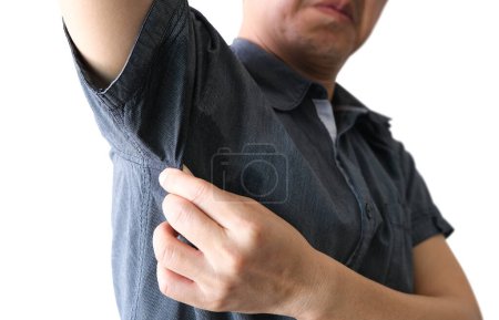 The man is wearing a blue shirt. He touches the armpit that is sweaty and is unclean. Health care concept