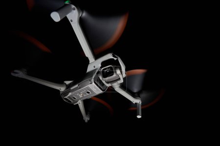 Photo for Nurtingen, Germany - June 26, 2021: Drone dji air 2s. Isolated on black. Illuminated with 1 flash at night. Side up view. Wide angle. - Royalty Free Image