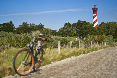 Téléchargez les photos : Phare en Hollande. Vélo sur le chemin. Cyclisme aux Pays-Bas, Zélande, West Schouwen. - en image libre de droit