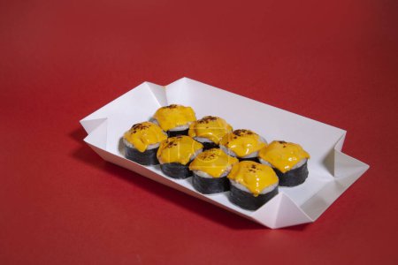 Photo for A box of sushi roll with a cheese on top - Royalty Free Image
