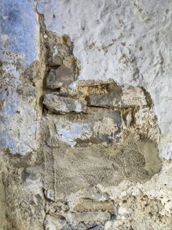 Photo for Texture of a deteriorated old wall, with a partially repaired spalling, vertical - Royalty Free Image