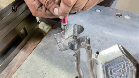 Photo for A toolmaker adjusting a plastic injection mold with a grinder, mechanical adjustment of a mold, die setter adjusting hands working - Royalty Free Image