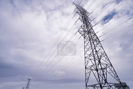 Photo for High voltage power lines, high voltage electric transmission tower for producing electricity at high voltage electricity poles, cloudy sky, high voltage pylons horizontal - Royalty Free Image