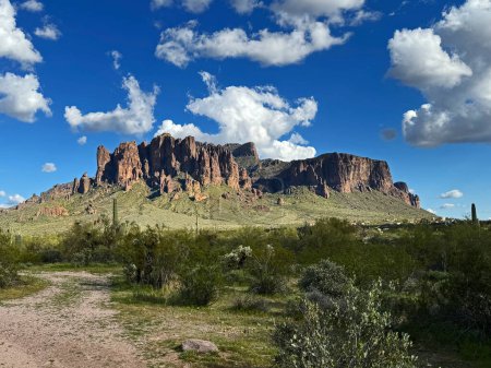 A scenic view of Flatiron in the Superstition mountains in the Lost Dutchman State Park in Apache junction near Phoenix, Arizona with beautiful blue sky and copy space.