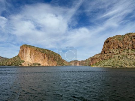 View from a steamboat, of Canyon Lake reservoir, Mormon Flat Dam and rock formations in Maricopa County, Arizona in the Superstition Wilderness of Tonto National Forest formed from the Salt River.