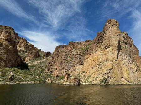 View from a steamboat, of Canyon Lake reservoir and rock formations in Maricopa County, Arizona in the Superstition Wilderness of Tonto National Forest near Apache Trail. The lake was formed by damming the Salt River as part of Salt River Project.
