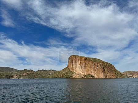 View from a steamboat, of Canyon Lake reservoir, Mormon Flat Dam and rock formations in Maricopa County, Arizona in the Superstition Wilderness of Tonto National Forest formed from the Salt River.