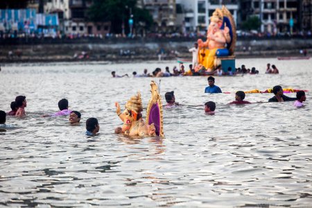Photo for India, Maharashtra, Mumbai, September 09, 2010: Devotees carry a idol of Lord Ganesh for immersion at Girgaum Chowpatty in the Arabian Sea. - Royalty Free Image