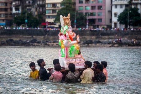 Photo for India, Maharashtra, Mumbai, September 09, 2010: Devotees carry a idol of Lord Ganesh for immersion at Girgaum Chowpatty in the Arabian Sea. - Royalty Free Image