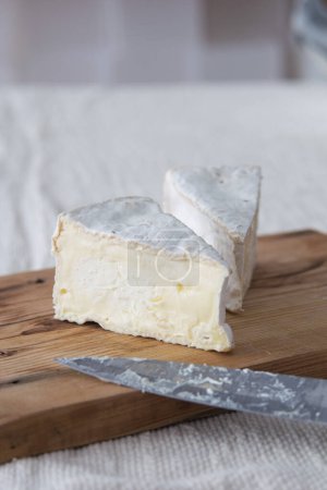Photo for Piece of camamber brie cheese on wooden board. Selective focus - Royalty Free Image