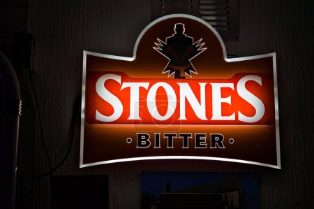 Photo for Illuminated Stones bitter brand sign in a local English pub. - Royalty Free Image