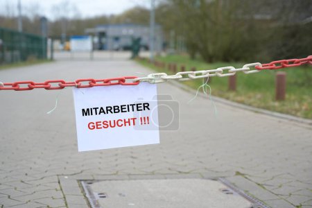 Photo for Entrance of a company with hanging sign and german text Mitarbeiter gesucht, english meaning Employees wanted, concept for increasing shortage of workers due to demographic change, copy space, selected focus - Royalty Free Image