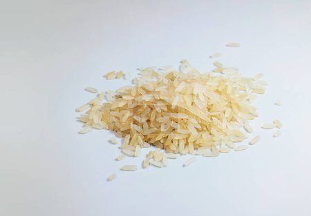 Photo for Small heap of uncooked parboiled rice, also called converted rice, on a light gray background, copy space, selected focus, narrow depth of field - Royalty Free Image