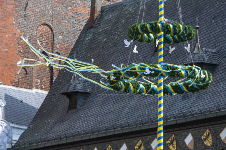 Maypole con palomas blancas de la paz y flameando cintas amarillas azules, colores de la bandera de Ucrania, frente al ayuntamiento de Lubeck, Alemania, mayo de 2022, espacio para copiar, enfoque seleccionado