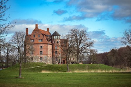 Ulrichshusen Castle is an important Renaissance building in the Mecklenburg Lake District in Germany, the brick building in the landscape park is now used as a hotel, blue sky with clouds, copy space