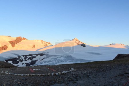Téléchargez les photos : Panorama de neige de montagne, sommet Johannisberg (Haute Tauern) et site d'atterrissage en hélicoptère au lever du soleil à Glockner Group, Autriche - en image libre de droit