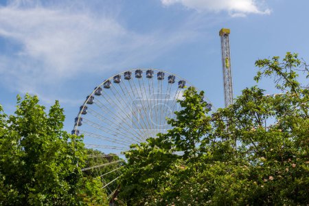 Ferris wheel and drop tower at Volksfest Erlangener Bergkirchweih in Erlangen, Germany