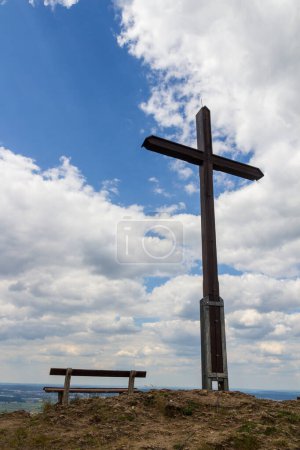 Cruz de la cumbre y banco en la colina Rodenstein en Suiza francófona, Alemania