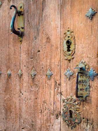 Locks and knockers on an old wooden door, Spain, Europe