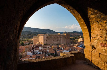 Mora de Rubielos city skyline with a view of the historical buildings through an arch of the wall, Teruel, Spain