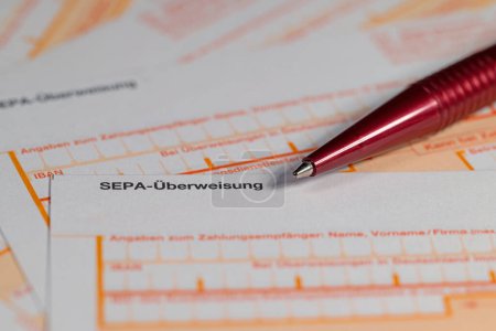 Photo for Transfer slip for money in Europe with the imprint "SEPA-Ueberweisung",translation "SEPA transfer" - Royalty Free Image