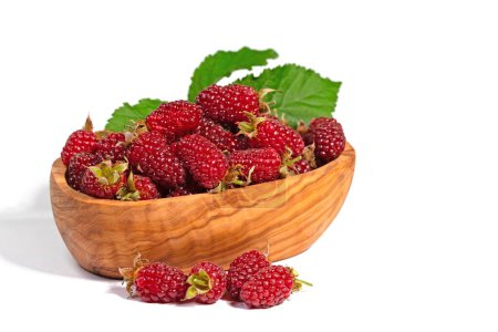 Tayberries in a wooden bowl against a white background