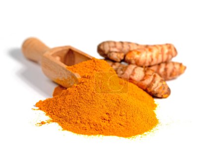 Ground turmeric root against white background