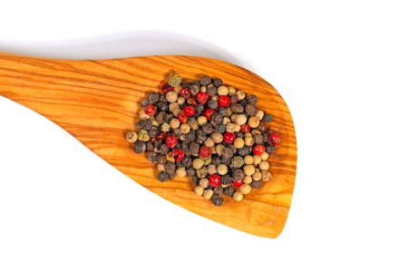 Colorful peppercorns on a wooden spoon