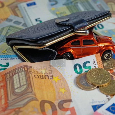 Car on banknotes, symbolic of fuel costs