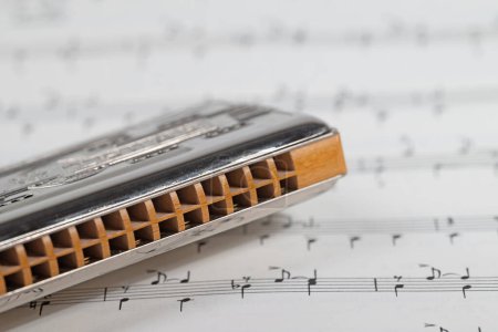 Photo for Harmonica and music notes in a close-up - Royalty Free Image
