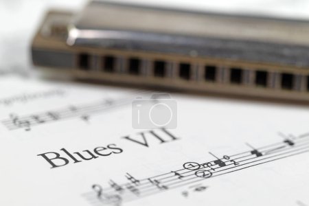 Photo for Harmonica and music notes in a close-up - Royalty Free Image