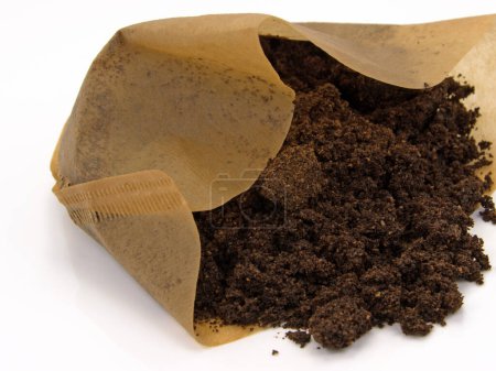 Filter bag with coffee grounds against a white background