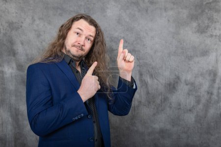 A stylish young man with long hair is dressed in a striking blue suit, exuding confidence and charisma as he poses in a series of stances, showcasing his unique and fashionable style.