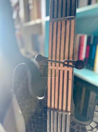 Photo for Abstract Composition of Guitar on Chair with Soft Focus and Bokeh, Backlit with Warm Light - Royalty Free Image