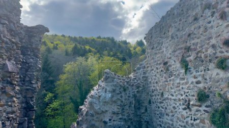 Ancient Hugstein Castle Ruins Overlooking Florival Valley, Alsace, with Springtime Verdure and Dynamic Sky