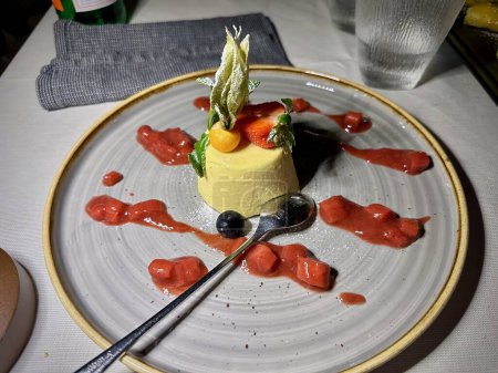 Exquisite Vanilla Panna Cotta with Fresh Strawberry, Blueberry, and Passion Fruit Garnish on Artistic Plate