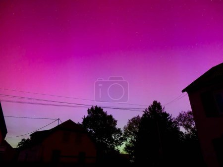 Guebwiller, France - May 10 2024 : Brilliant Aurora Borealis Display with Shades of Pink and Purple Over European Night Sky