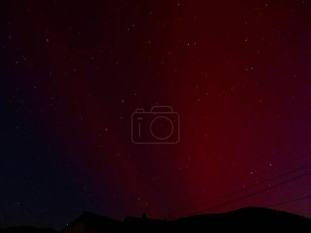 Guebwiller, France - May 10 2024 : Stunning Aurora Borealis Display Over Europe with Vibrant Red and Purple Hues Illuminating the Night Sky