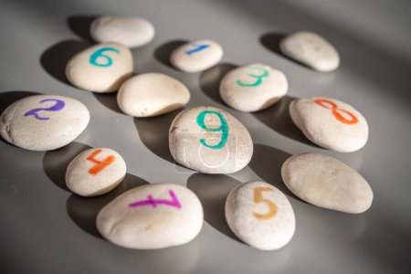 Colorful stones signed by numbers, an alternative method of children education. Number 9 in center. High quality photo