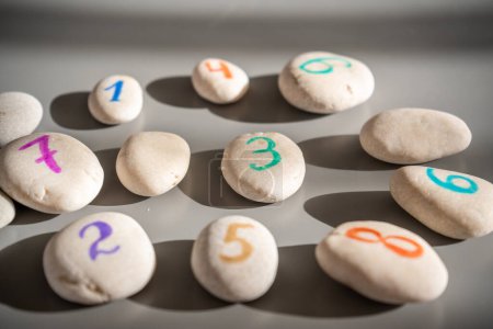 Colorful stones signed by numbers, an alternative method of children education. Number 3 in center. High quality photo