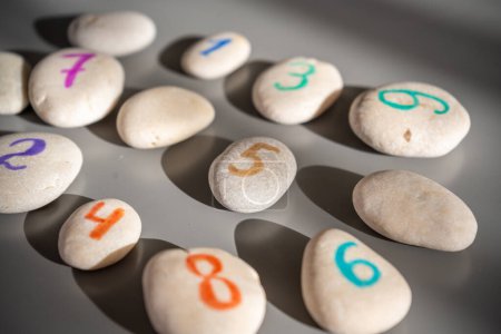 Colorful stones signed by numbers, an alternative method of children education. Number 5 in center. High quality photo