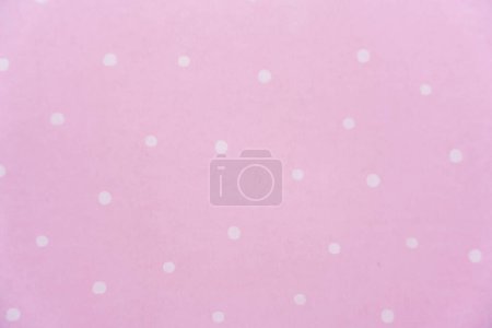 White polka dot on pink background. Paper pattern. High quality photo