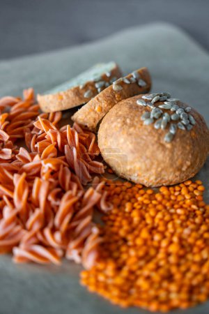 Photo for Red lentil fusilli pasta and Vegan Lentil Bread on a gray background. Gluten free food. High quality photo - Royalty Free Image