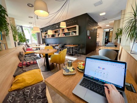 Prague, Czech republic - September 7, 2023: Interior of non-stop cafe with space for study. Coworking place popular among students for education and study in Prague. High quality photo