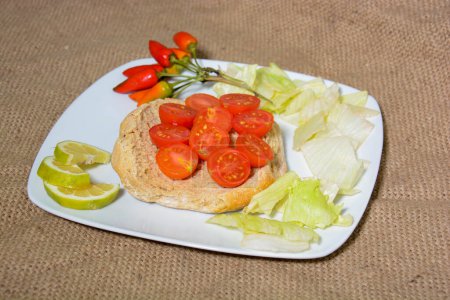 Photo for Finger food typical of southern Italy seasoned with cherry tomatoes, oil, salt and oregano - Royalty Free Image