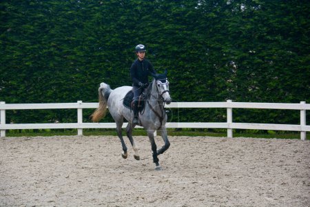 Italian horsewoman in country riding shows trim and balance rider and horse