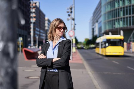 Photo for Portrait of confident business woman in suit, cross arms on chest, looking self-assured in city center, standing on street. Corporate people - Royalty Free Image
