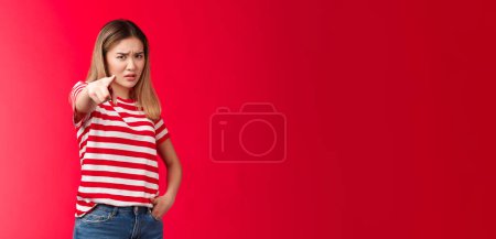 Photo for Girl plead you guilty. Upset asian blond girlfriend being cheated on pointing camera blame person make accusations, frowning disappointed and hurt, stand red background bothered offended. - Royalty Free Image