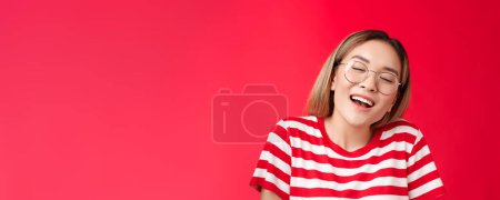 Photo for Happy dreamy glad asian girl feel stuffed good after eating favorite sandwich, woman wear glasses close eyes delighted smiling broadly opened mouth fantasizing, dreaming tasty burger. - Royalty Free Image